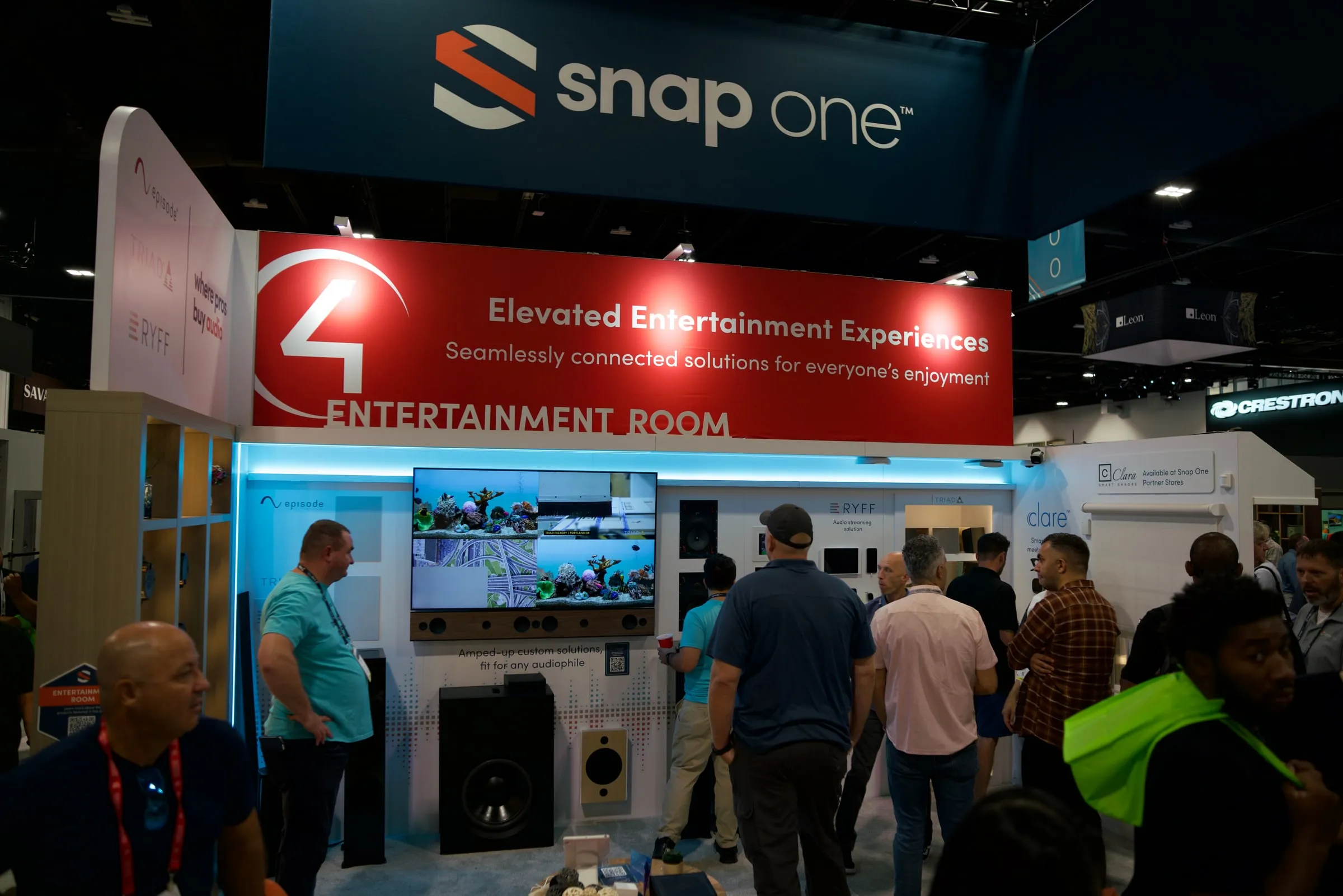 Busy entertainment room demo area with a red Control4 header