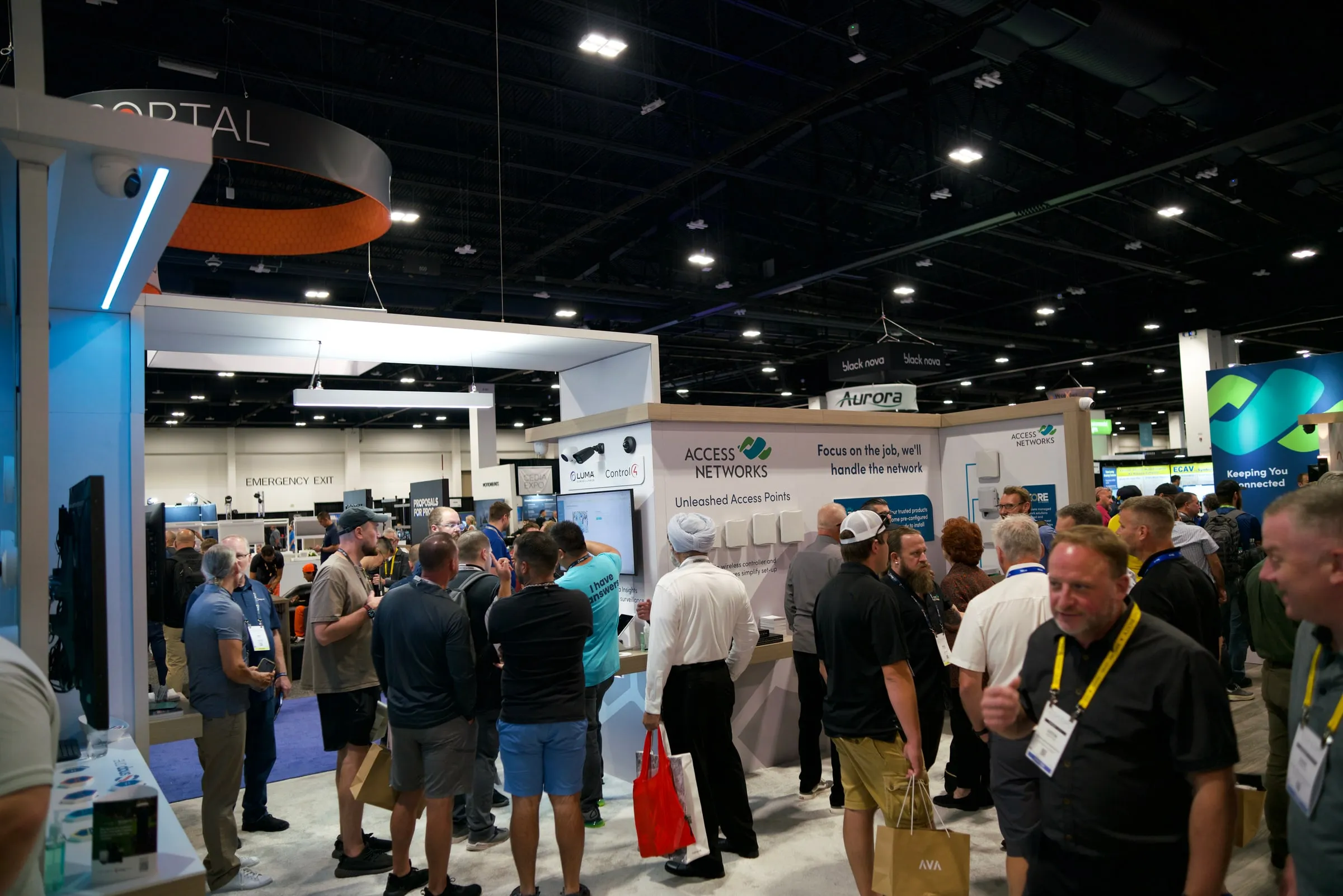 Visitors moving through the booth aisle