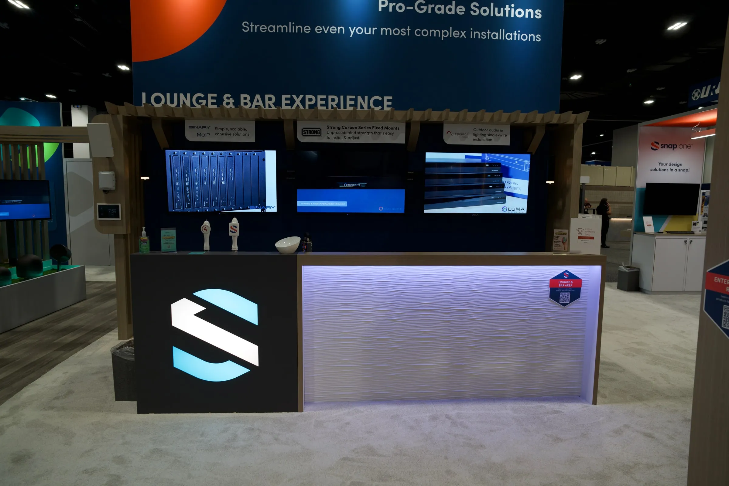 "Lounge and Bar Experience" counter with a lit Snap One S logo