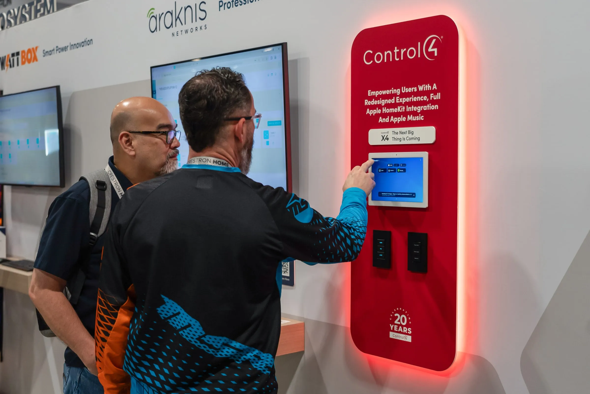 Visitor using a Control4 touch panel on a red-lit display