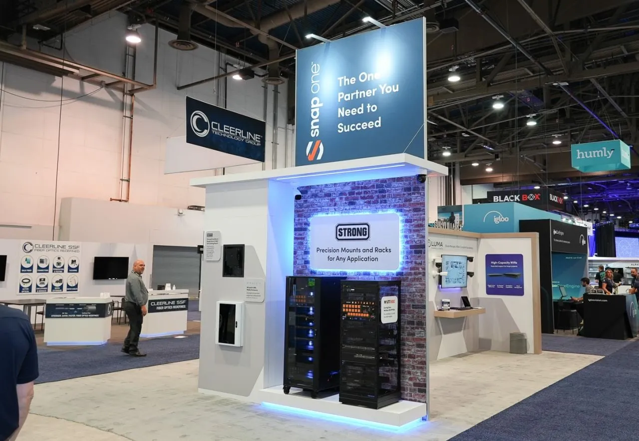 Booth tower with a Snap One header and a blue-lit equipment rack