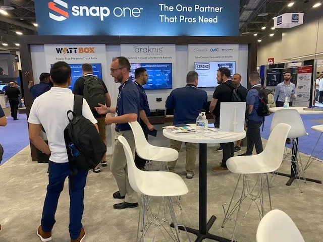 Visitors at tall tables under the "The One Partner That Pros Need" header