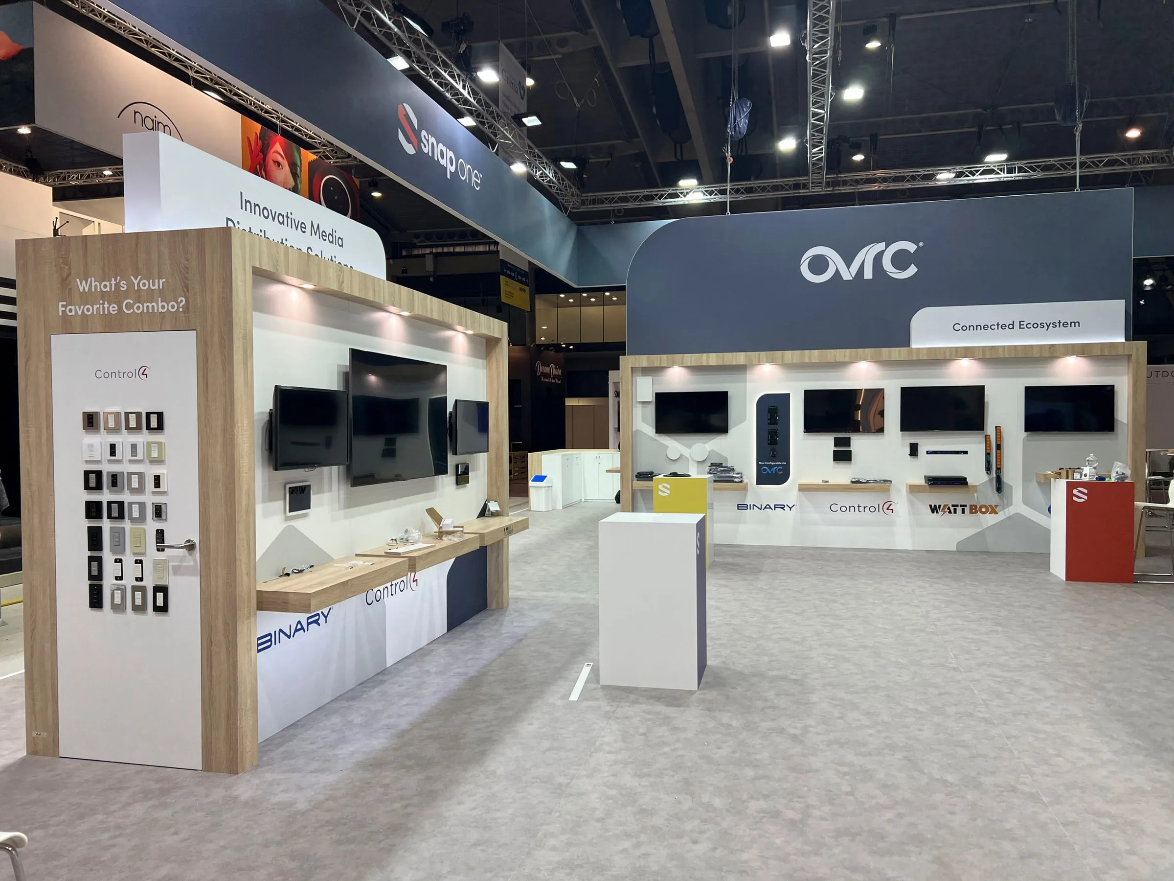 Finished ISE 2023 booth: OvrC wall with TVs and product displays