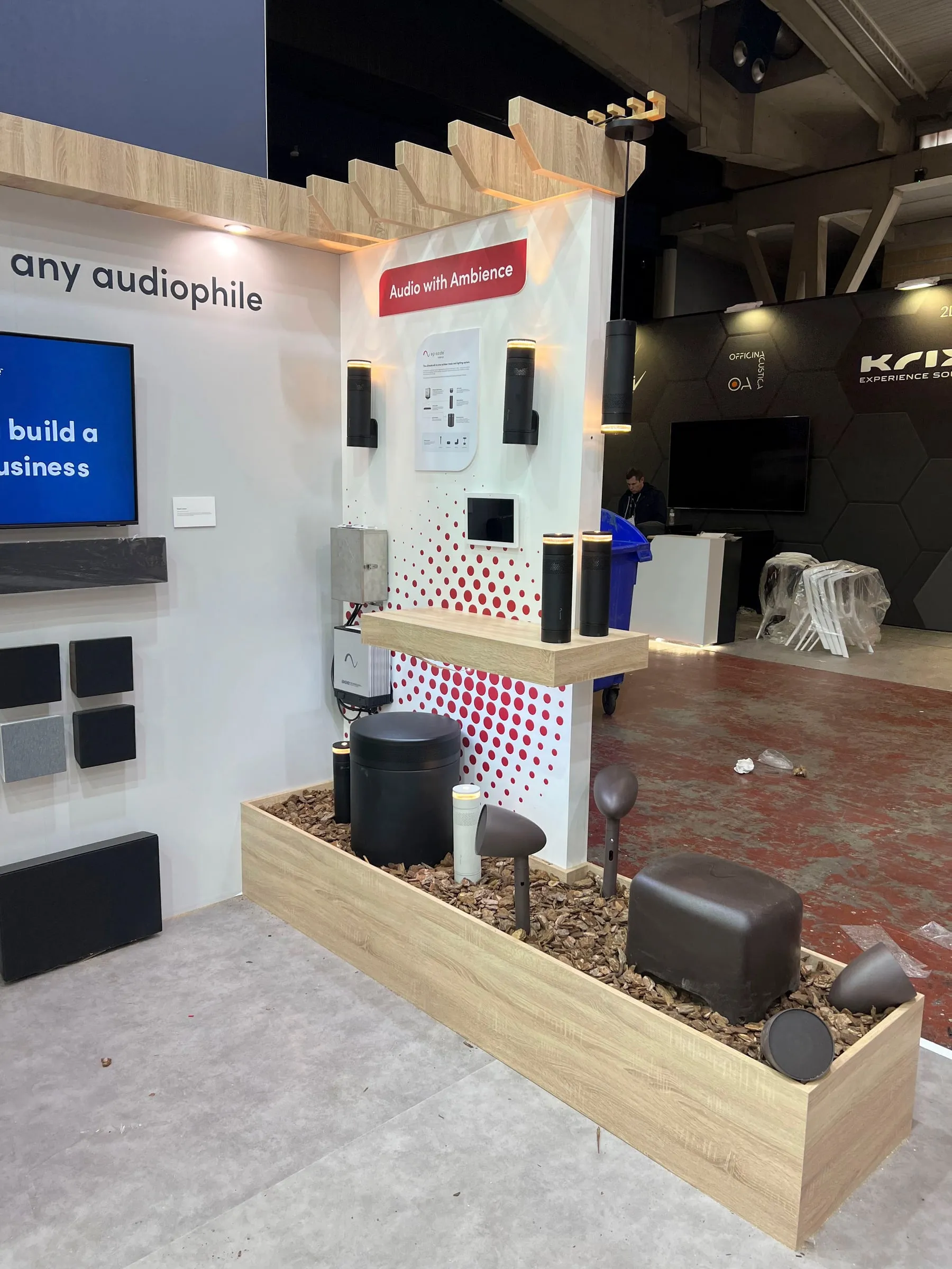 Episode audio corner with speakers and a wood slat tower