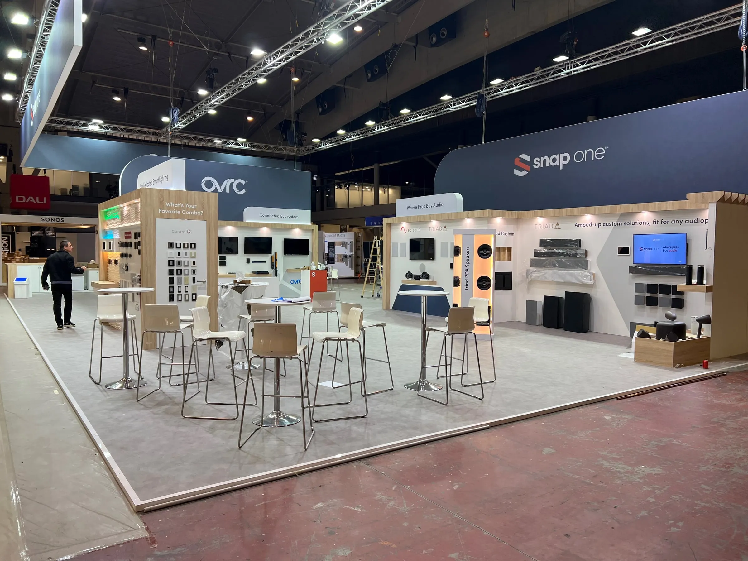 Wide view of the ISE 2023 booth with tall tables and product walls