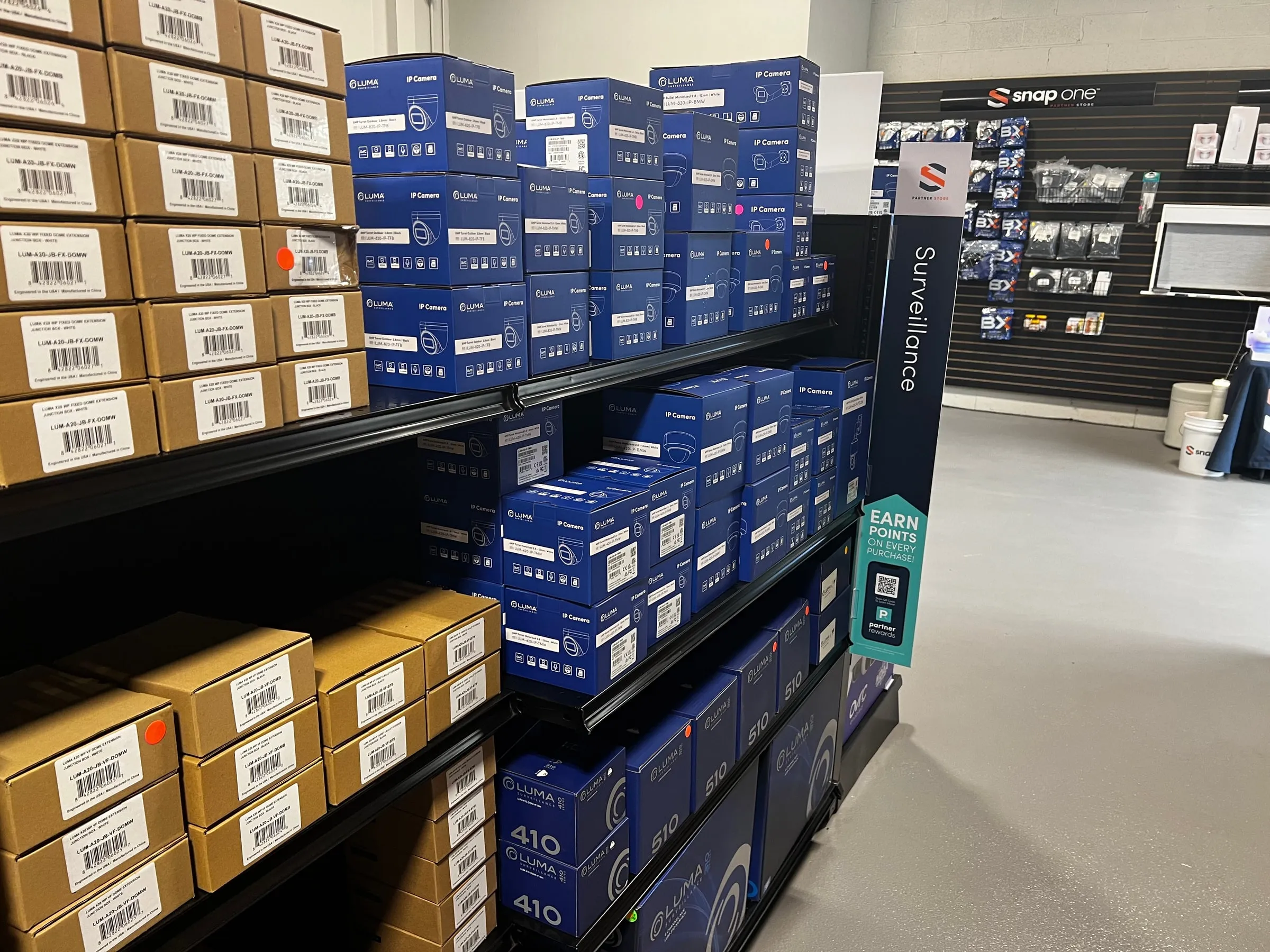 Luma boxes stocked on store shelves at a Snap One local branch