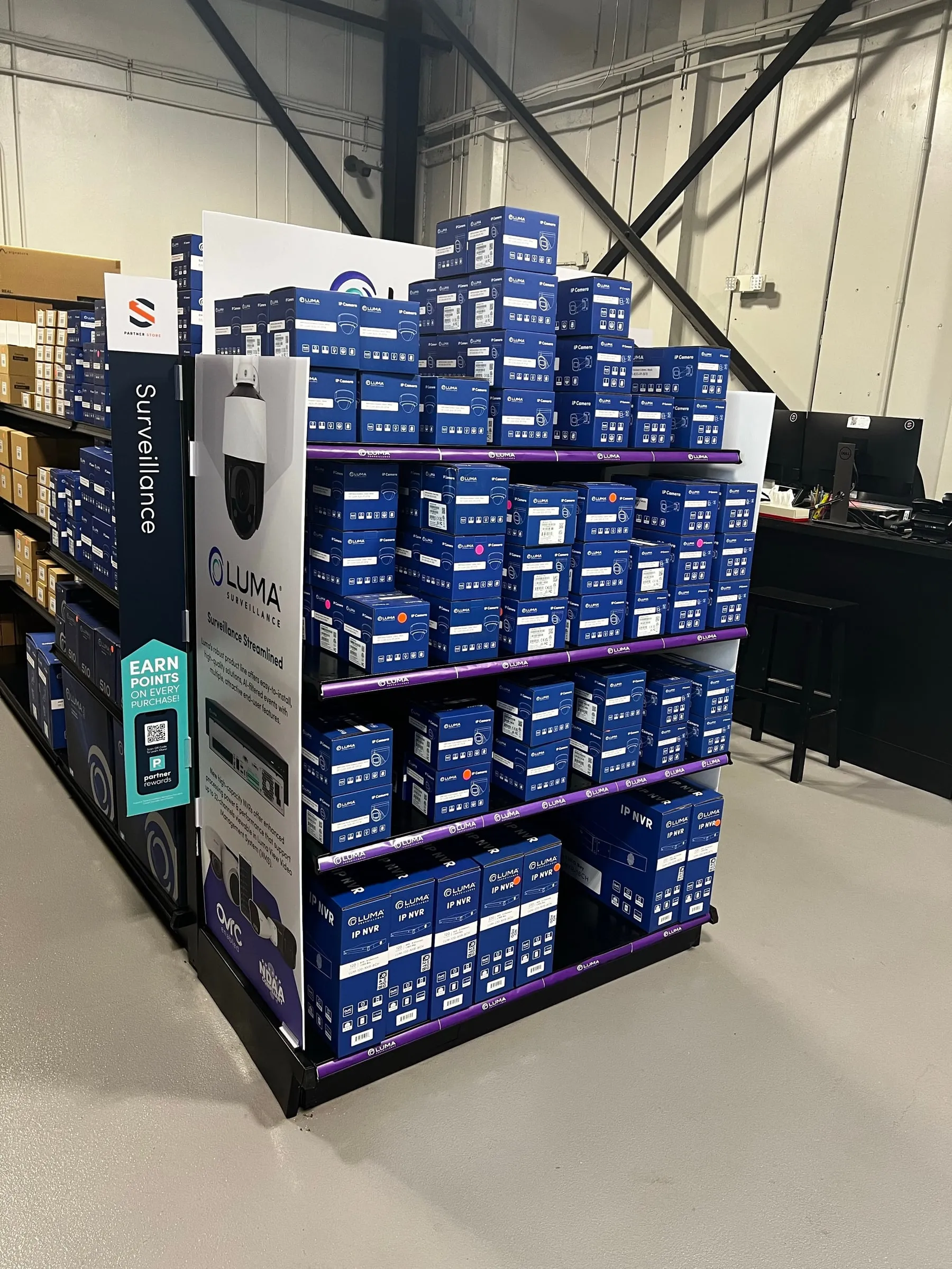 Endcap display of blue Luma boxes in a Snap One store