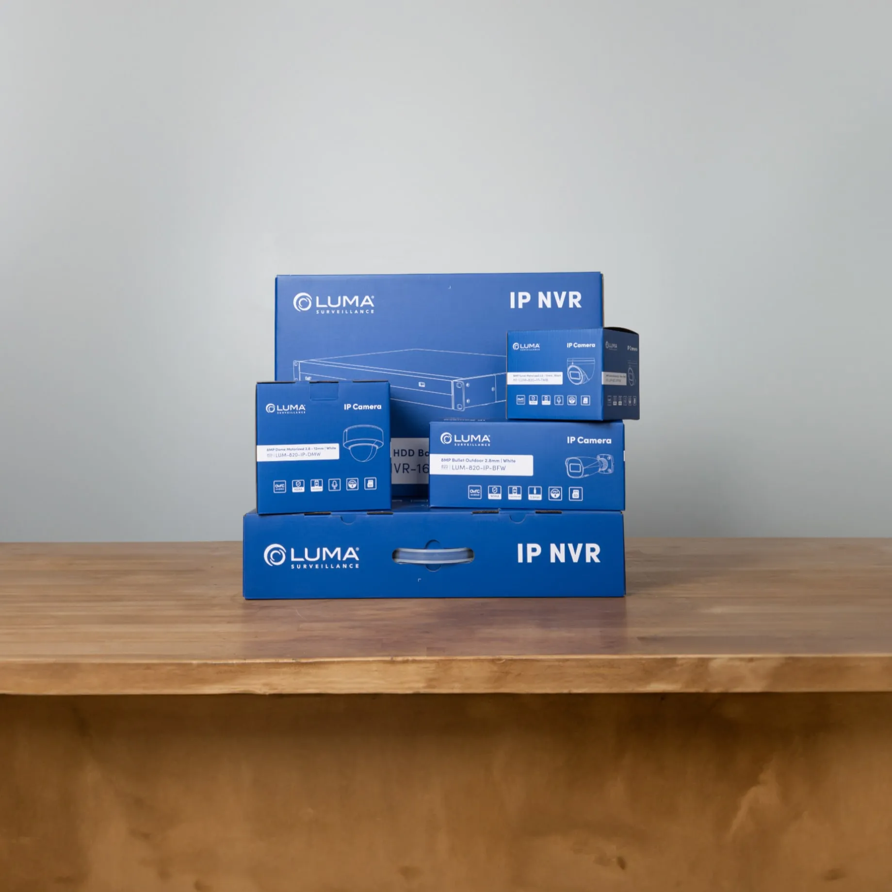 Stack of finished blue Luma boxes on a wooden table