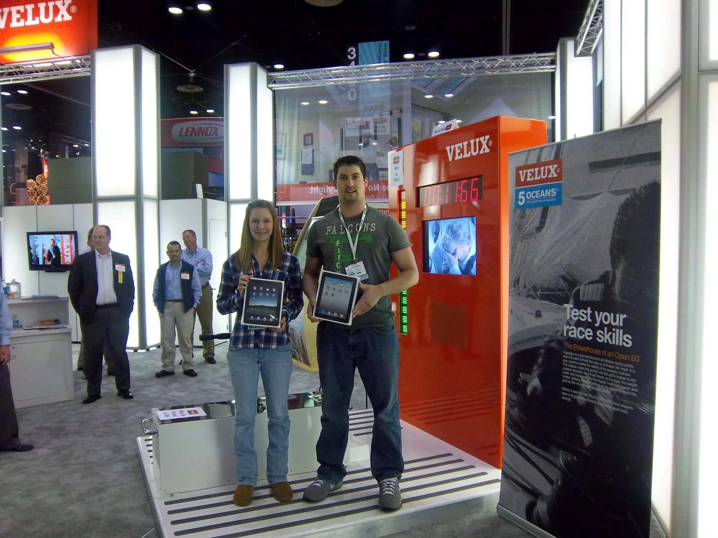 Two visitors holding tablets at the VELUX booth