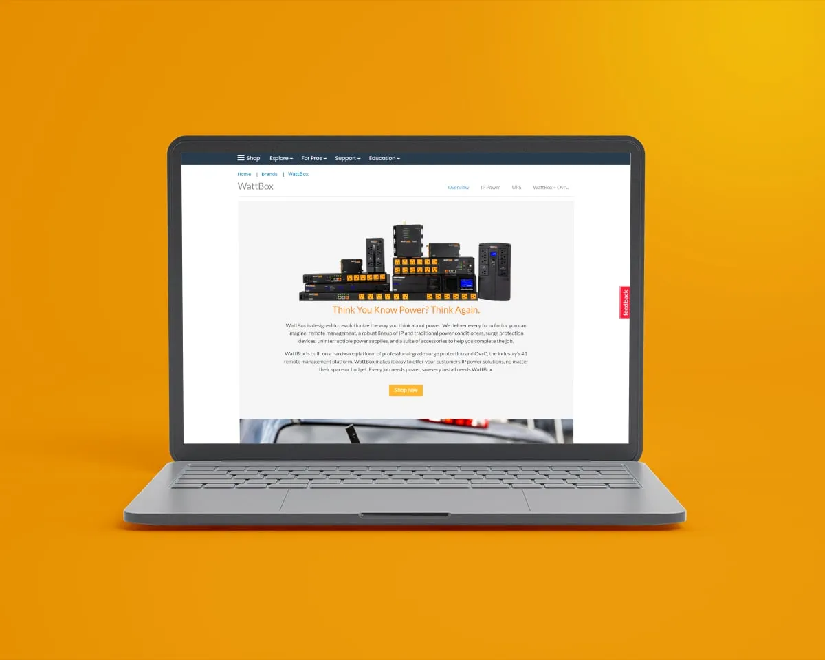 WattBox brand page on a laptop against an orange background